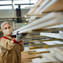 manual-worker-with-face-mask-stacking-wood-planks-2024-12-13-18-51-55-utc (1)